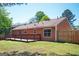 This backyard features a wood deck, privacy fence, and plenty of green space for outdoor activities at 4691 Garden Hills Ct, Stone Mountain, GA 30083