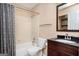 Standard bathroom with a shower-tub combo, wood vanity, dark countertop and mirror at 4691 Garden Hills Ct, Stone Mountain, GA 30083