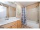 Bathroom with a wooden vanity, large mirror, and a shower-tub combo at 4691 Garden Hills Ct, Stone Mountain, GA 30083