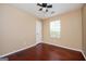 Bright bedroom featuring hardwood floors, a ceiling fan, and neutral paint at 4691 Garden Hills Ct, Stone Mountain, GA 30083