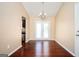 Dining area with hardwood floors, double doors to the backyard, and modern chandelier at 4691 Garden Hills Ct, Stone Mountain, GA 30083