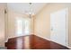 Open dining area with hardwood floors, double doors to the backyard, and modern chandelier at 4691 Garden Hills Ct, Stone Mountain, GA 30083