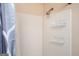 Shower with white tiled walls and wire shelving at 4691 Garden Hills Ct, Stone Mountain, GA 30083