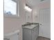 Contemporary bathroom featuring a modern vanity with granite counters and a bright window at 250 Stonecreek Pkwy, Covington, GA 30016