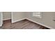 Corner of a bedroom with light-colored walls, hardwood floors and bright window at 250 Stonecreek Pkwy, Covington, GA 30016
