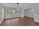Bright dining room with hardwood floors, modern light fixture and large windows at 250 Stonecreek Pkwy, Covington, GA 30016