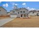 Charming two-story home with a brick-accented porch and attached two-car garage at 250 Stonecreek Pkwy, Covington, GA 30016