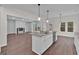 Open kitchen and living area with an island, stainless appliances, and stone countertops at 250 Stonecreek Pkwy, Covington, GA 30016