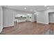 Bright and open-concept living room with hardwood floors, modern kitchen and fireplace at 250 Stonecreek Pkwy, Covington, GA 30016