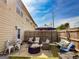 Inviting backyard patio with stylish outdoor furniture, including a dining table and cushioned seating area for relaxation and entertaining at 304 Commons Dr, Jonesboro, GA 30236