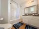 Bathroom featuring a shower-tub combo, a white vanity and wood-look floors at 304 Commons Dr, Jonesboro, GA 30236