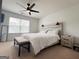 Bedroom with a decorative headboard, ceiling fan, and large window at 304 Commons Dr, Jonesboro, GA 30236