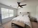 Bright bedroom featuring a ceiling fan and a large window with blinds at 304 Commons Dr, Jonesboro, GA 30236