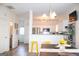 Bright dining area offers contemporary lighting, and easy access to the adjacent kitchen area, fostering seamless entertaining at 304 Commons Dr, Jonesboro, GA 30236