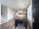 Bright dining area offers contemporary lighting, and easy access to the adjacent kitchen area, fostering seamless entertaining at 304 Commons Dr, Jonesboro, GA 30236