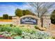 The Battle Creek Commons entrance sign, surrounded by colorful flowers, creates a welcoming atmosphere at 304 Commons Dr, Jonesboro, GA 30236