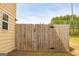Side yard with a gated wooden fence, providing access and security to the backyard at 304 Commons Dr, Jonesboro, GA 30236