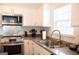 Updated kitchen area featuring stainless steel appliances and stylish backsplash at 304 Commons Dr, Jonesboro, GA 30236