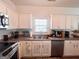 Kitchen boasting stainless steel appliances, including a dishwasher, and bright white cabinetry at 304 Commons Dr, Jonesboro, GA 30236
