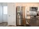 Bright kitchen features stainless steel appliances, white cabinets, and a dark countertop island at 304 Commons Dr, Jonesboro, GA 30236