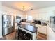 Bright kitchen boasts stainless steel appliances, a kitchen island, and ample white cabinetry offering storage space and functionality at 304 Commons Dr, Jonesboro, GA 30236