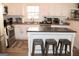 Well-lit kitchen showcasing stainless steel appliances, white cabinets and a stylish backsplash at 304 Commons Dr, Jonesboro, GA 30236