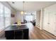 Open-concept living and dining area boasts wood floors and stairs at 304 Commons Dr, Jonesboro, GA 30236