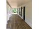 Long covered front porch with stained wood floor, white columns, and an open view at 25 Dove Pt, Covington, GA 30016