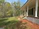 Inviting front yard showcasing the covered porch and landscaped surroundings at 25 Dove Pt, Covington, GA 30016