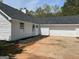 Exterior side view with a two car garage and paved driveway at 25 Dove Pt, Covington, GA 30016
