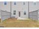 A fenced backyard with a grass lawn and a small patio, perfect for outdoor relaxation and entertaining at 1516 Parks Edge Nw Ln, Atlanta, GA 30318