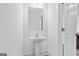 Well-lit powder room featuring a pedestal sink and modern fixtures for guests at 1516 Parks Edge Nw Ln, Atlanta, GA 30318