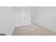 Bright bedroom featuring neutral carpet and double door closet with an open doorway leading to the next level at 1516 Parks Edge Nw Ln, Atlanta, GA 30318