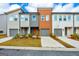 Charming townhome featuring a well-manicured lawn and a gray garage door, inviting and stylish curb appeal at 1516 Parks Edge Nw Ln, Atlanta, GA 30318