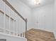 Bright foyer showcasing wood-look flooring, a staircase with white banisters, and a white front door at 1516 Parks Edge Nw Ln, Atlanta, GA 30318