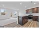 Spacious kitchen featuring a kitchen island and a backyard view that brings warmth and light to the room at 1516 Parks Edge Nw Ln, Atlanta, GA 30318