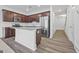 Open kitchen design featuring stainless steel appliances, granite counters, island, and dark wood cabinetry at 1516 Parks Edge Nw Ln, Atlanta, GA 30318