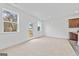 Bright living room, adjacent to kitchen, with carpeted floors and backyard access, creating a seamless indoor-outdoor living at 1516 Parks Edge Nw Ln, Atlanta, GA 30318