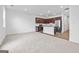 Bright living room showcasing carpeted floors, a kitchen, and large windows offering ample natural light at 1516 Parks Edge Nw Ln, Atlanta, GA 30318