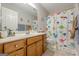 -friendly bathroom with a dinosaur-themed shower curtain and a light wood vanity at 2705 Maple Park Pl # 29, Cumming, GA 30041