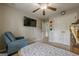 Well-lit bedroom featuring a ceiling fan, closet, and a television at 2705 Maple Park Pl # 29, Cumming, GA 30041