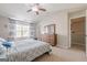 Spacious bedroom featuring a window, ceiling fan, and a dresser at 2705 Maple Park Pl # 29, Cumming, GA 30041