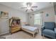 Bright bedroom featuring a ceiling fan, natural light, and a cozy sitting area at 2705 Maple Park Pl # 29, Cumming, GA 30041
