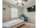 Cozy bedroom featuring a large window, ceiling fan, and comfortable chair at 2705 Maple Park Pl # 29, Cumming, GA 30041