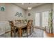 Inviting dining room with wooden table, six chairs, and natural light from the door at 2705 Maple Park Pl # 29, Cumming, GA 30041