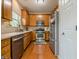 Well-lit kitchen featuring stainless steel appliances, wood cabinets, and hardwood flooring at 2705 Maple Park Pl # 29, Cumming, GA 30041