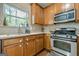 Charming kitchen featuring stainless steel appliances, wood cabinets, and a view from over the sink at 2705 Maple Park Pl # 29, Cumming, GA 30041
