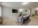 Open living room with neutral carpet, a large flat-screen TV, and comfortable gray seating at 2705 Maple Park Pl # 29, Cumming, GA 30041