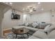 Cozy living area featuring a large sectional, round coffee table, and wall-mounted TV at 2705 Maple Park Pl # 29, Cumming, GA 30041