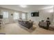 Spacious living room with neutral carpet, a cozy gray sofa set, and plenty of natural light at 2705 Maple Park Pl # 29, Cumming, GA 30041
